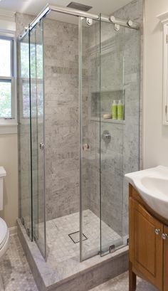 a bathroom with a walk in shower next to a sink