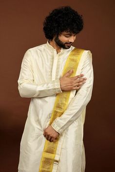 Off-white pattu kurta featuring zardozi and gold thread embroidery on the neckline and sleeve hem. Paired dhoti pant and a kanduva. - Aza Fashions Traditional Drape Kurta With Tilla For Eid, White Sherwani With Gota Work For Navratri, Navratri White Sherwani With Gota Work, White Dabka Churidar For Puja, Puja Sherwani With Transitional Style And Traditional Drape, Puja Sherwani With Traditional Drape, White Traditional Drape Sherwani For Puja, Transitional Sherwani With Gota Work For Puja, White Bandhgala For Puja Transitional Season