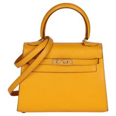 Hermès JAUNE COURCHEVEL LEATHER KELLY 20CM SELLIER CONDITION NOTES The exterior is in very good condition with moderate signs of use, with darkening on the handle and small marks on the leather. The interior is in excellent condition with light signs of use. The hardware is in very good condition with light signs of use. There are some visible scratch marks. The corners are in excellent condition with light signs of use. Overall this item is in very good pre-owned condition. Please note the majo Leia Sfez, Rare Fashion, Structured Shoulder, Hermes Kelly Bag, Hermes Accessories, Kelly Bag, Jane Birkin, Basket Bag, Yellow Leather