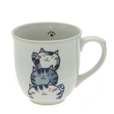 a white coffee cup with a cat design on it