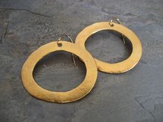 This item is made to order please allow 5 to 8 business days for your order to ship. A simple earring, yet with a lot of character. This is a great alternative to the classic round hoop. These 14 k gold plated whimsical hoop earrings where hand carved out of wax and cast in sterling silver. I then gave them my uneven textured signature finish followed by a soft semi-matte gold plating. They measure 1 1/2 inches in width and 1 1/4 inches in height, and dangles of a 14k gold filled ear wire. Also Gold Open Circle Hoop Earrings, Nickel-free Gold Open Circle Earrings, Gold Brass Oval Hoop Earrings, Gold Nickel-free Open Circle Earrings, Gold Oval Brass Hoop Earrings, Gold Open Circle Nickel-free Earrings, Gold Oval Hoop Earrings In Brass, Oval Gold Hoop Earrings In Brass, Gold Nickel-free Open Circle Hoop Earrings