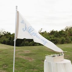 Add a unique touch to your wedding decor with a custom wedding pennant flag! Crafted in a classic 16"x36" size, this one-sided flag is perfect for wedding entrances, reception decor, or as a photo backdrop. Available in white or navy, each flag is made to order, with your personalized message beautifully hand-lettered for a look that’s both timeless and memorable. Key Features: Customizable 16"x36" pennant flag, perfect for personalizing with your wedding date, initials, or a special message One-sided flag design in white or navy to complement any wedding theme Durable, high-quality fabric with reinforced edges for long-lasting display Perfect for: Coastal weddings Rustic or vintage-themed ceremonies Reception decor, welcome signs, and guest photo backdrops Order your custom wedding flag t Americana Wedding Theme, Fabric Welcome Sign Wedding, Wedding Pennant, Coastal Weddings, Wedding Flags, Wedding Event Decor, Welcome Signs, Pennant Flag, Photo Backdrops