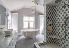 a bath room with a tub a sink and a mirror on the wall in it