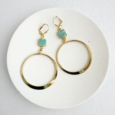 Make a bold statement with these exquisite Gold Hoop Statement Earrings featuring captivating Amazonite stones. Perfectly blending timeless elegance with a modern twist, these hoops showcase the natural beauty of Amazonite, known for its calming and soothing properties. Handcrafted with high-quality materials, these earrings are ideal for elevating both everyday looks and special occasions. Silver Spoon Jewelry, Long Statement Earrings, Earrings Gold Hoop, Hoop Dangle Earrings, Dangle Earrings Gold, Amazonite Stone, Spoon Jewelry, Gold Statement Earrings, Earrings In Gold