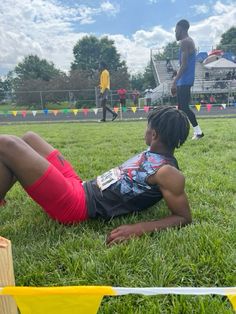 a young man laying on the ground with his legs spread out in front of him