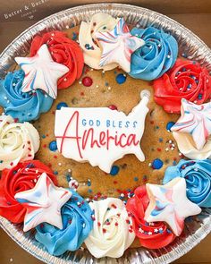 an american flag cookie decorated with red, white and blue icing in a pie tin