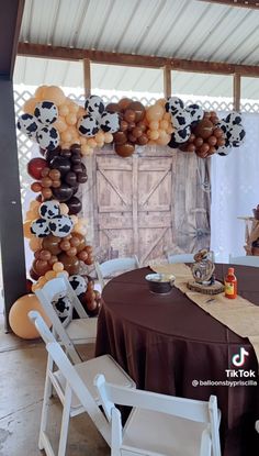 the table is set up for a party with balloons and pandas on it, along with other decorations