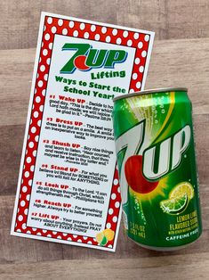 a can of zup soda next to a sign on a wooden table with information about it