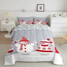 a bed with snowmen and santa hats on it