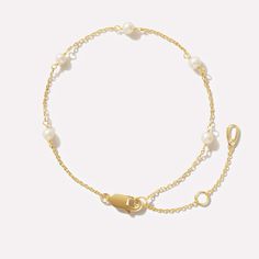 More than just your grandma’s hand-me-downs, this pearl station bracelet is our modern take on a 1980s classic. This dainty must-have bracelet is dipped in 14K gold and adorned with five freshwater pearls. Your arm candy isn’t complete without its main course: pearls. So go ahead and start your stack off strong with the Adelie pearl station bracelet then layer on some fan favorites like our Rowena and Lisa bracelets. • Dainty bracelet with adjustable sizing • Dipped in 14K gold Classy Jewelry Bracelets, Dainty Chain Bracelet, Pearl And Gold Bracelet, Gold And Pearl Bracelet, Bracelets Dainty, Recruitment Ideas, Party Styling, Gold Pearl Bracelet, Prom Inspo