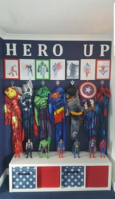 there are many superheros on the shelf in this boys's room, including captain america and iron man