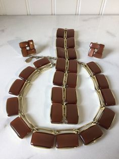 Glamorous vintage signed LISNER lucite/thermoset parure.  A rich cocoa brown color set in gold tone, the necklace, bracelet, and earrings are in very good condition.  There is minimal surface wear to the cabochons.  The gold tone finish shows some wear to the edges and back.  This is not unusual for vintage jewelry of this age, being circa 50s to 60s.  All pieces are signed LISNER.  A spectacular example of vintage costume jewelry, this collectible is still fashionable today. I HAVE NOT CLEANED THIS SET. Thanks for shopping alliesjewelbox.Etsy.com Jan Brown Bakelite Jewelry Gift, Brown Bakelite Jewelry As A Gift, Minimal Surface, Cocoa Brown, Vintage Glamour, Vintage Costume Jewelry, Vintage Costumes, Color Set, Necklace Bracelet