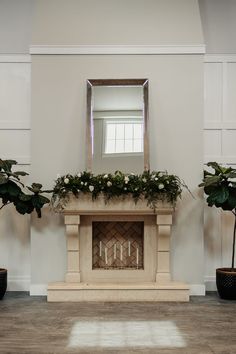 the fireplace is decorated with flowers and greenery