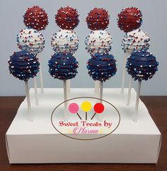 six red, white and blue lollipops on sticks with sprinkles