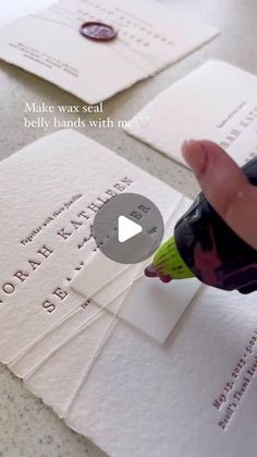 someone is writing on some white paper and using a marker to highlight the word'make wax seal '