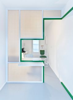 an empty bathroom with green and white accents on the walls, along with a bathtub