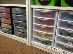 plastic bins with name labels on them are organized in a storage unit for children's toys