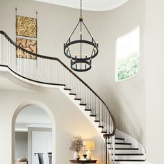 a living room filled with furniture and a spiral staircase