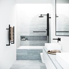 a white bathroom with two sinks, mirrors and a bathtub in the middle of it