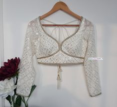 This Made to Order/Made to Measurement/Custom Made Indian Ethnic Blouse. - Fabric - Chikankari Georgette - Color - Off-White - Padded - Princess Cut - Sweetheart Neck - Rich lining  - Long Sleeves - Back Hook Closure - Shoulder String with Latkans PLEASE NOTE: BUYERS ARE RESPONSIBLE FOR ANY CUSTOMS AND IMPORT TAXES THAT MAY APPLY. This is a made to order product. If you opt for 'Made To Measurement Option', we will provide a measurement template and you can share the measurements likewise. If you want to opt for 'Standard Size', Please refer to the size chart provided in the listing. Shipping: Standard Shipping is done by DHL ecommerce and it mostly takes 2 to 3 weeks to deliver after dispatch. Express Shipping is done by DHL express and it mostly delivers within a week after dispatch. Fab Long Sleeve Indian Blouse, White Blouse Back Neck Designs, Transitional Season Fitted White Choli, Transitional Season White Fitted Choli, White Festive Tops For Navratri, Fitted Anarkali Blouse With Mirror Work, Bohemian Tops For Weddings And Festivals, Traditional Party Blouse With Chikankari Embroidery, White Chikankari Embroidery Party Blouse