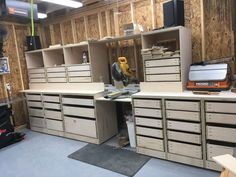 a room filled with lots of drawers next to a workbench and toolbox