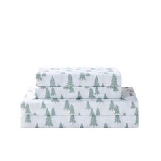 three sheets with trees on them in white and green colors, one is folded to the side