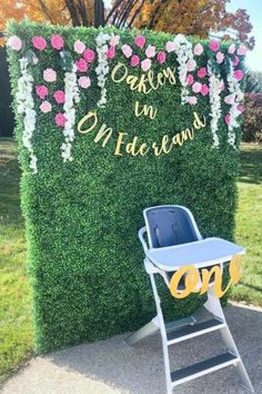 a baby's high chair sitting in front of a sign