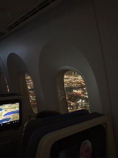 the view from inside an airplane looking out at city lights