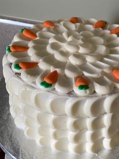 a white cake with orange and green decorations