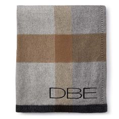 a blanket with the word dobe on it in black and brown plaid pattern,