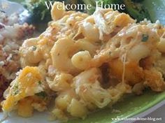 a green plate topped with macaroni and cheese next to broccoli