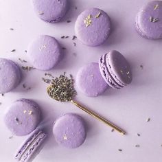 purple macaroons with sprinkles and a gold spoon