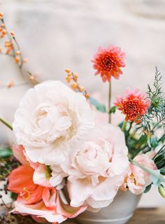 an arrangement of flowers in a vase on a table