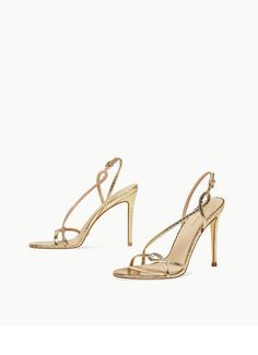 Luxury Gold Sandals With 4-inch Heel, Luxury Gold Heels With Heel Loop, Luxury Gold Sandals For Night Out, Glamorous Gold Sandals For Cocktail, Gold Pointed Toe Sandals For Gala, Chic Gold Sandals For Gala, Gold Sandals With Heel Strap For Cocktail, Gold Sandals With Heel Loop For Cocktail, Gold Strappy Evening Sandals