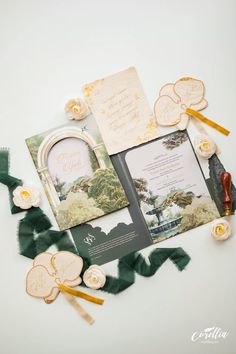 the wedding stationery is laid out on top of each other