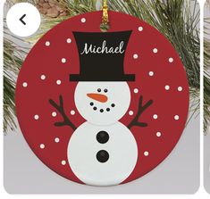 a christmas ornament with a snowman wearing a top hat