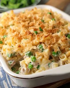 a casserole dish with peas and chicken in it