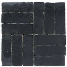 black slate tiles are stacked up on top of each other, with one block in the middle