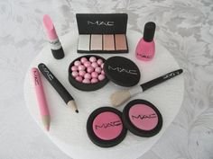 a cake with mac cosmetics and makeup on it