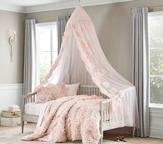 a bed with a pink canopy over it