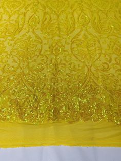 yellow sequins and mesh fabric on white background