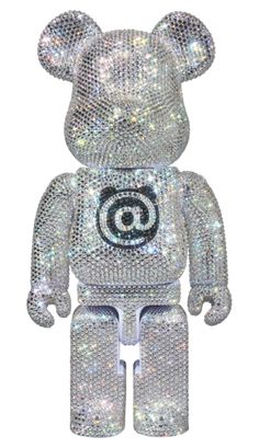 a bear made out of silver sequins with an at symbol on it's chest