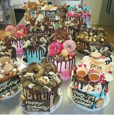 a table topped with lots of cakes covered in frosting and sprinkles