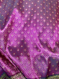 purple and green banaram saree with gold thread work on the border,