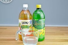 two bottles of vinegar, lemonade and water on a table