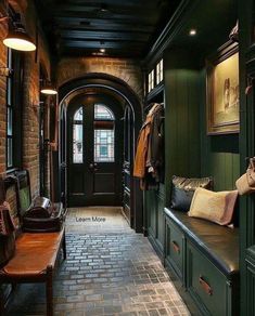 a hallway with green walls and brick flooring