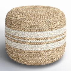 a white and beige round ottoman with stripes on it's sides, made out of jute