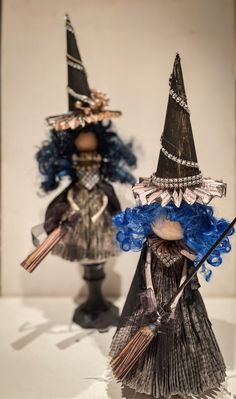 two dolls are dressed up as witches