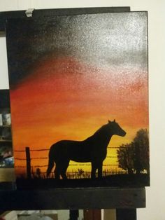 a painting of a horse standing in front of a fence at sunset with the sky painted on it