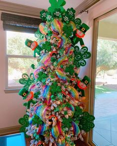 a very colorful christmas tree decorated with shamrocks